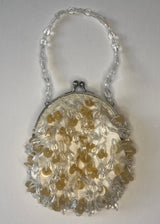 Decorative handbag with intricate design on a plain background