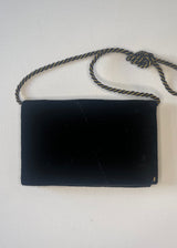 Black clutch bag with a rope handle on a white background