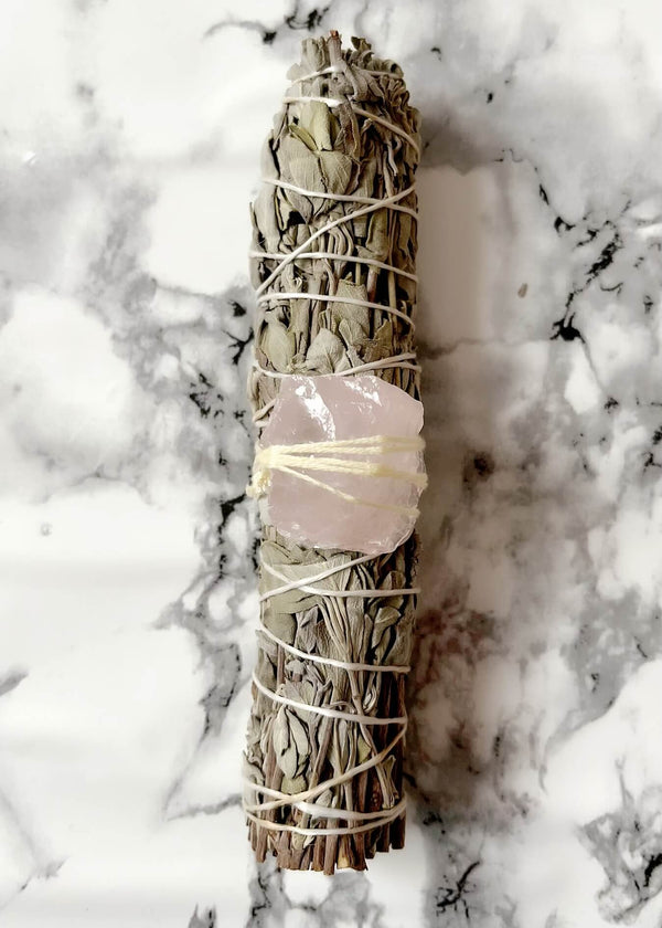 Sacred Smudging Wand // Rose Quartz - Large Sacred Smudging Wand with Rose Quartz. Each wand has been uniquely hand crafted with the intention to purify and cleanse, whilst respecting and honouring the sacred ancient traditions of Indigenous smudging ritual. Never leave flame unattended. Always extinguish fully. Each wand is unique and therefore may vary slightly from photo.